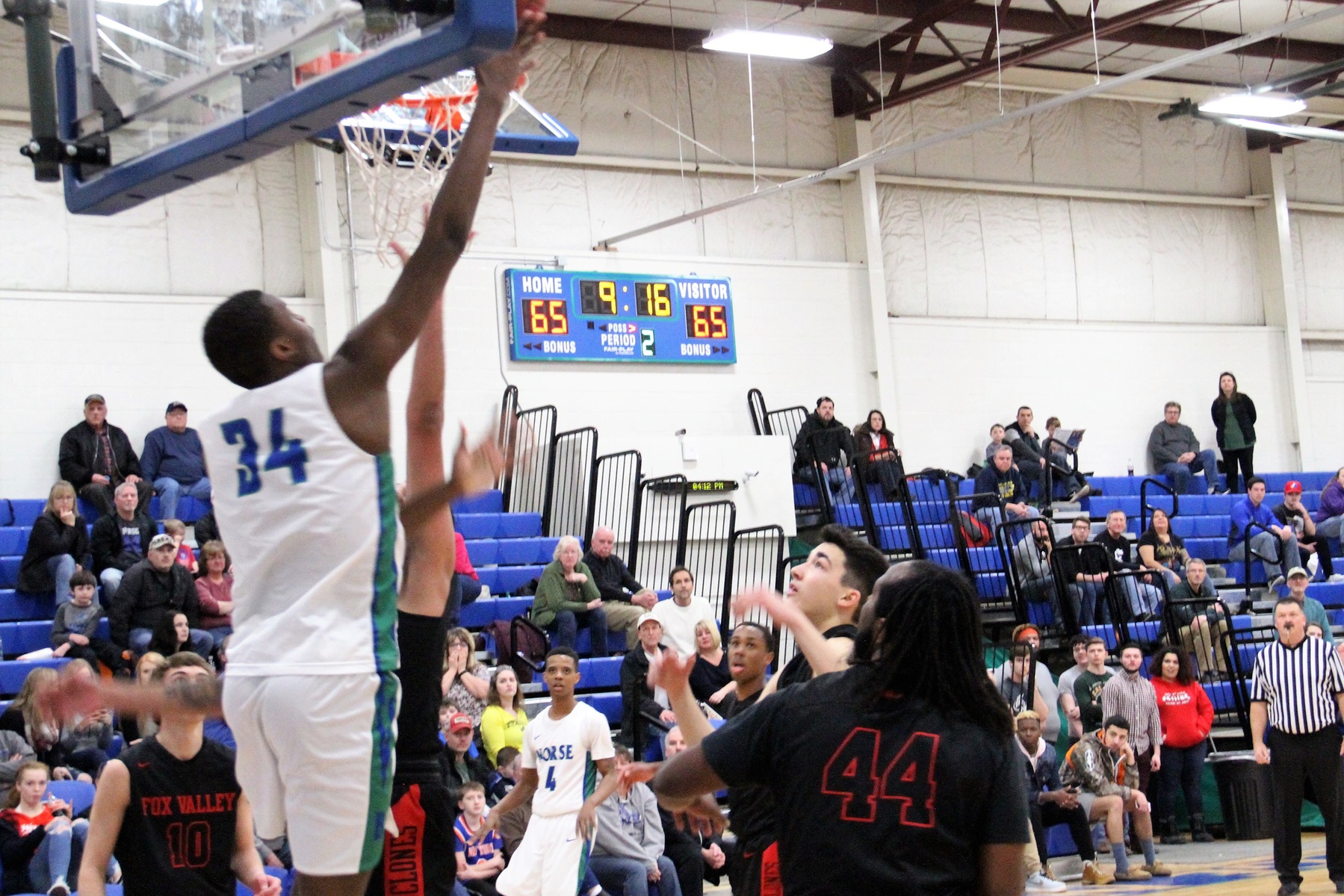 Kobi Barnes shooting a basket from underneath the backboard