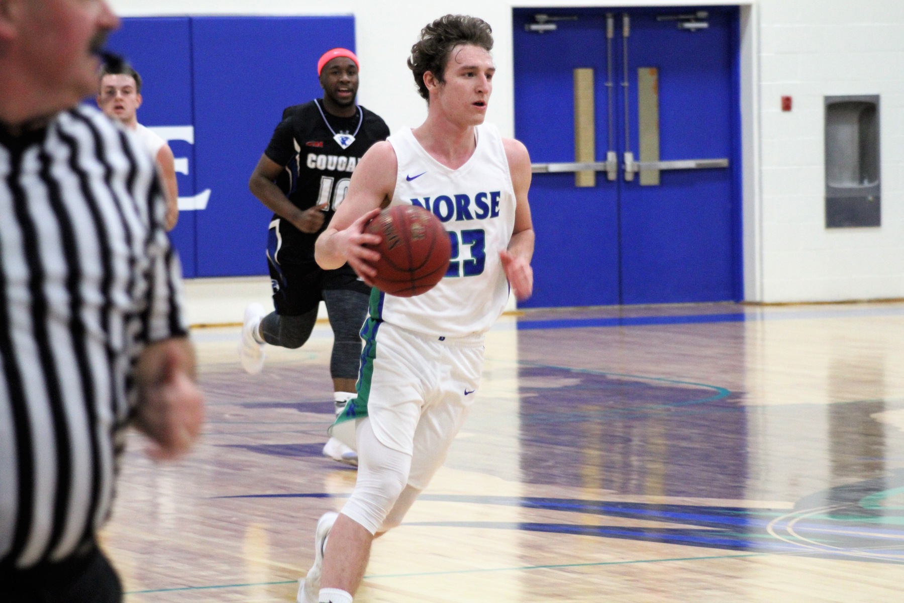 Marcus McKenney dribbling the ball up the court