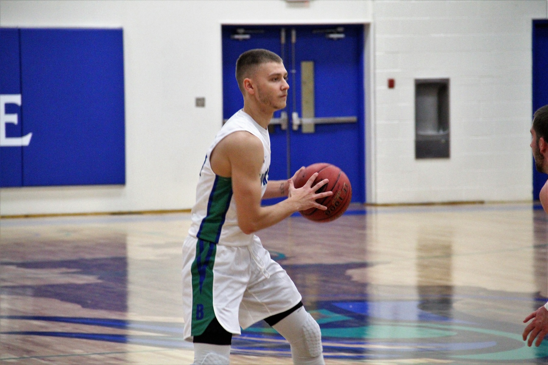 Dre Touminen holds the ball beyond the three point arc