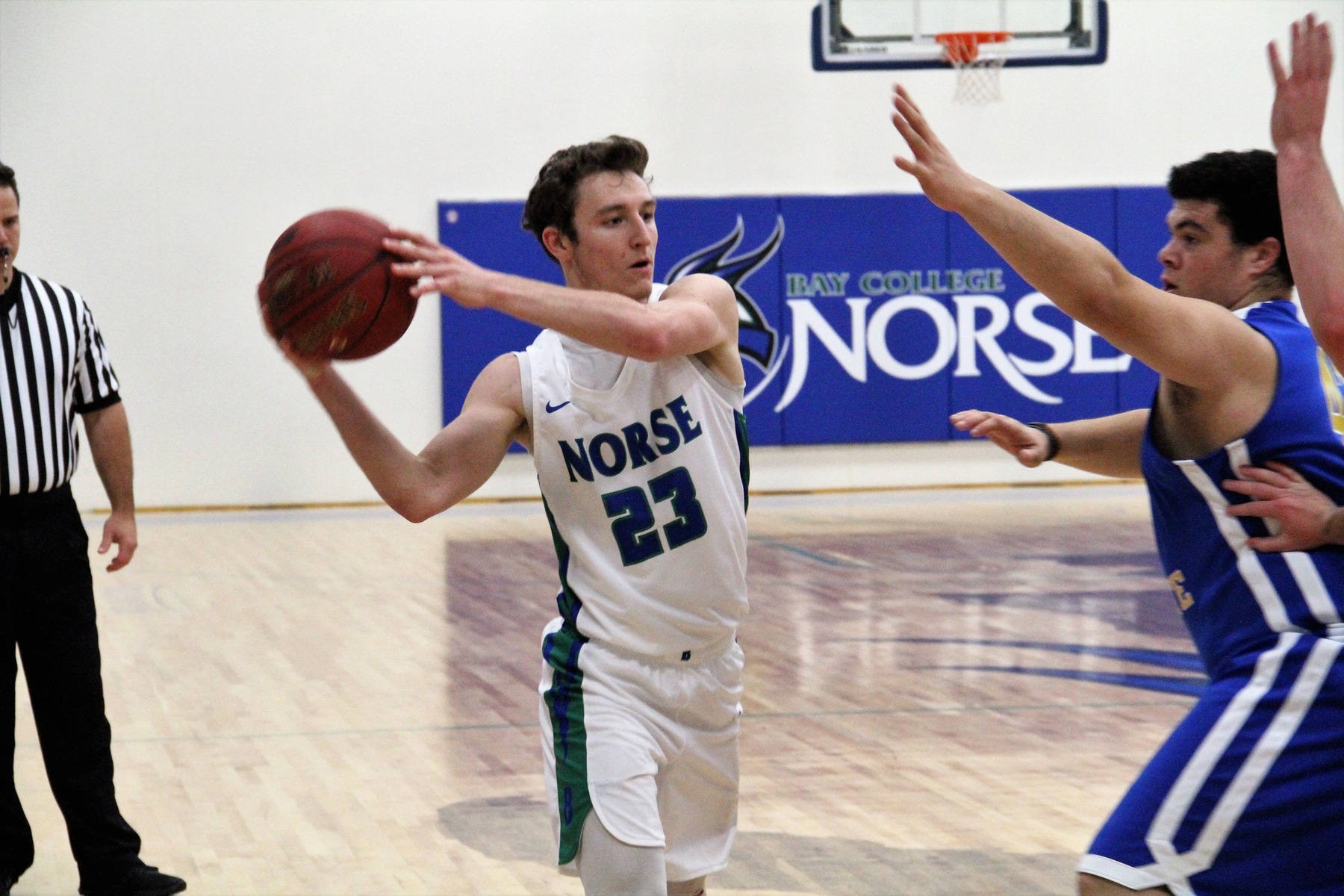 Marcus McKenney extends the ball to his side while a defender reaches out a hand