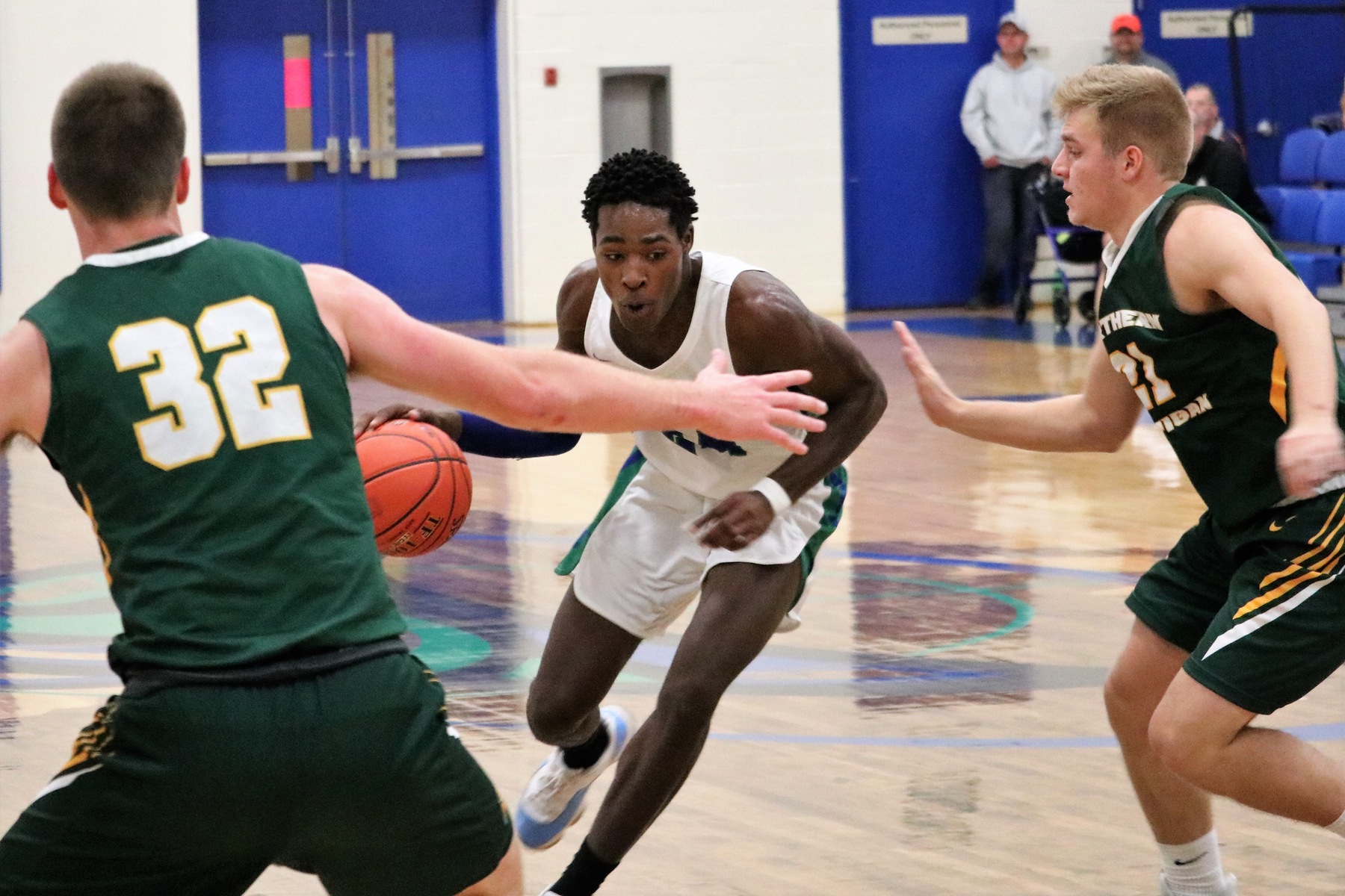 Xaviel Fields dribbles between two defenders
