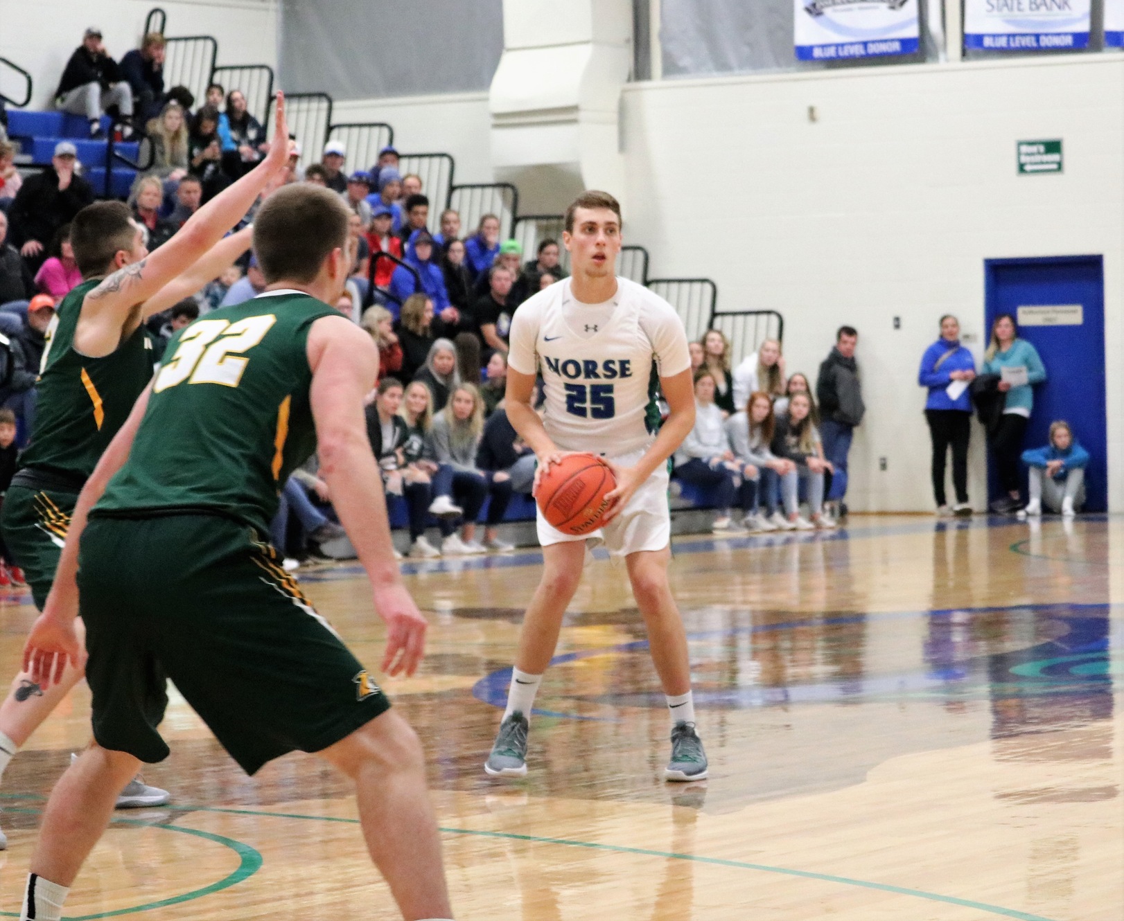 Tristan Masuga looking to pass from the top of the key