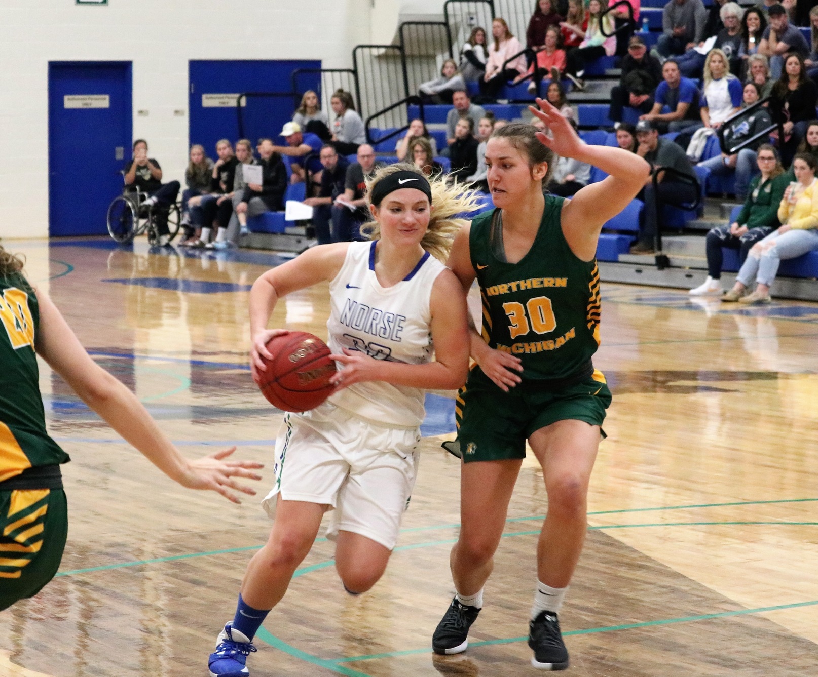 Holly Wardynski driving into the lane closely guarded