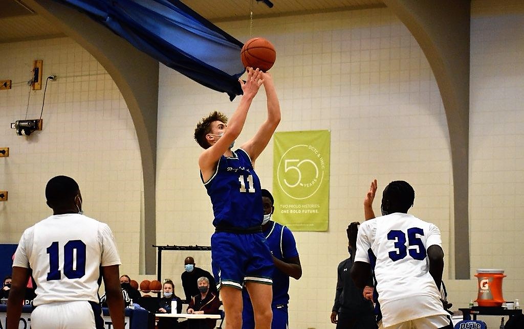 Ashton Janke in mid air, releasing a jump shot