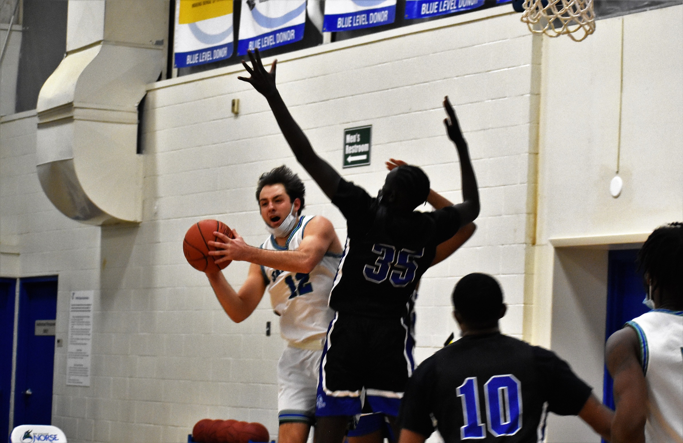 Matt Wagner looks to pass in the air as a defender stretches in front of him