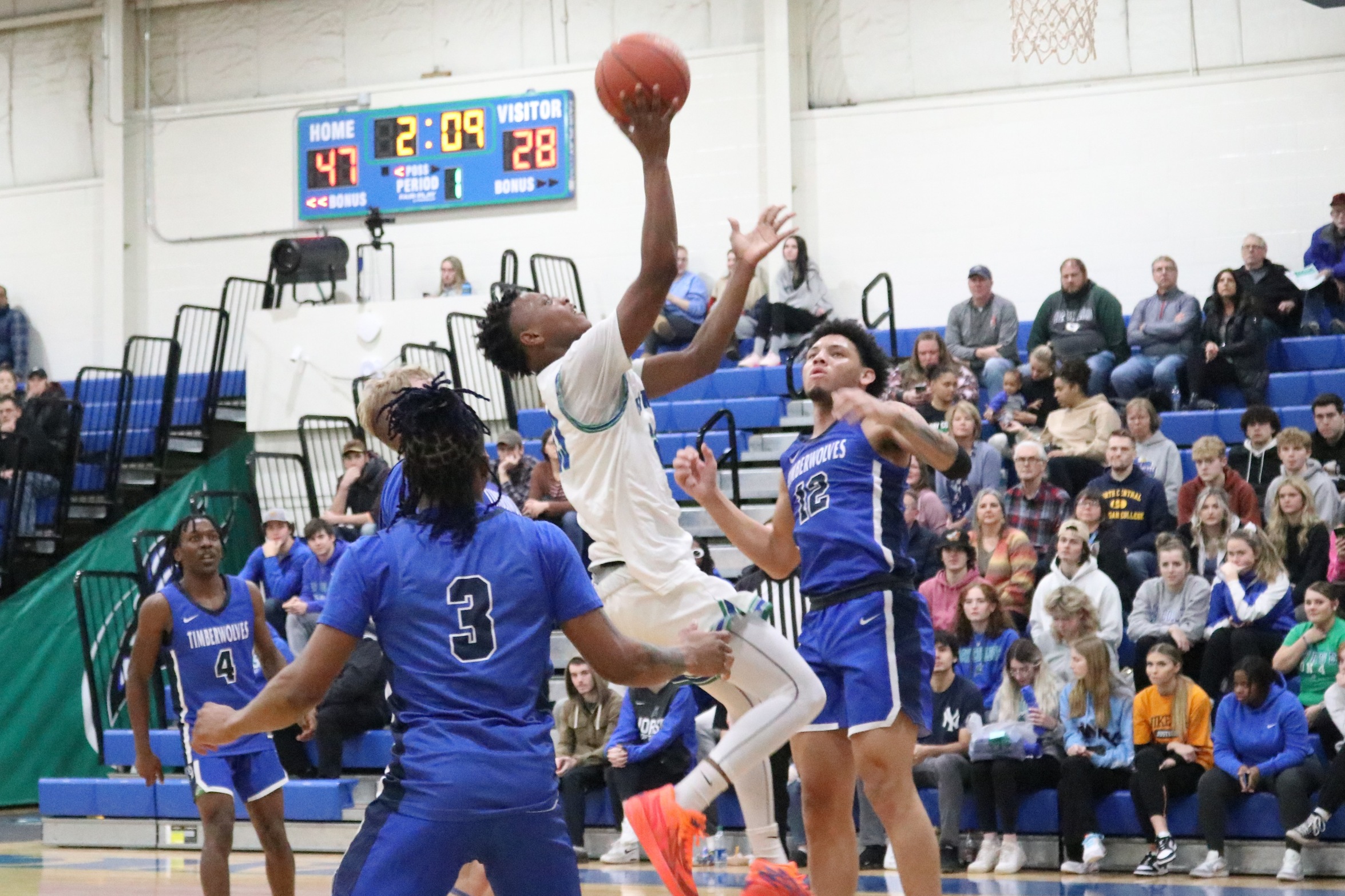 Lamar Grayson about to release a shot in the lane, a defender bearing down on him from behind