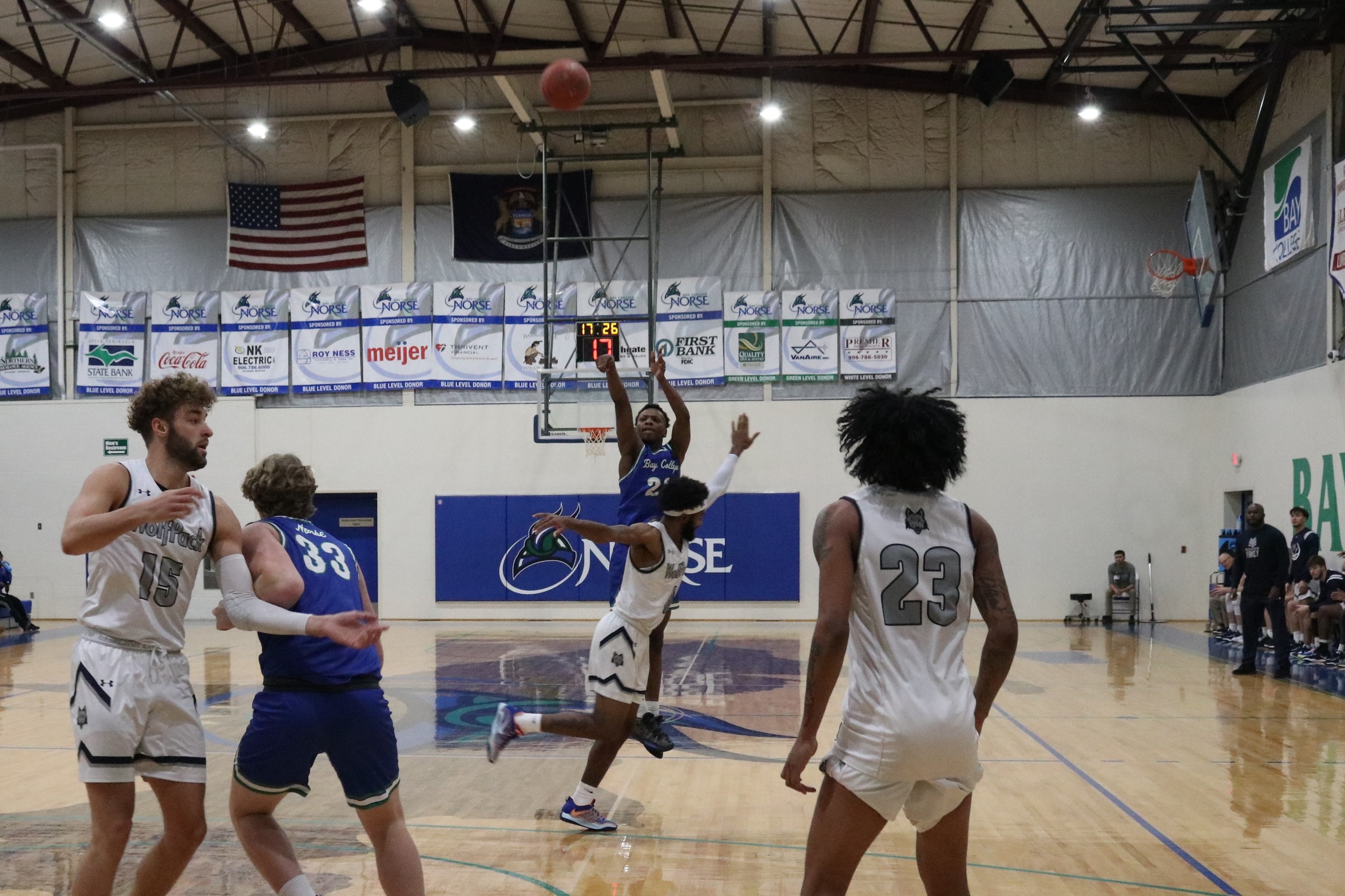 Lamar Grayson let's go of a three-point attempt as a defender flies by