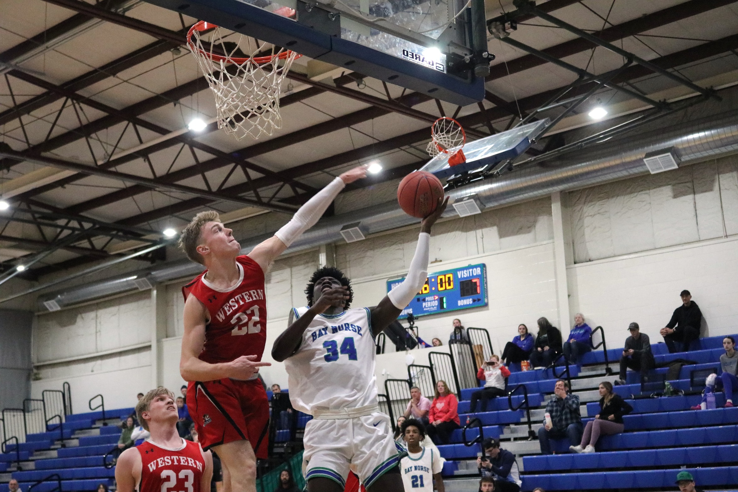 Joshua Ofori reaches up for a layup as a defender tries to block him