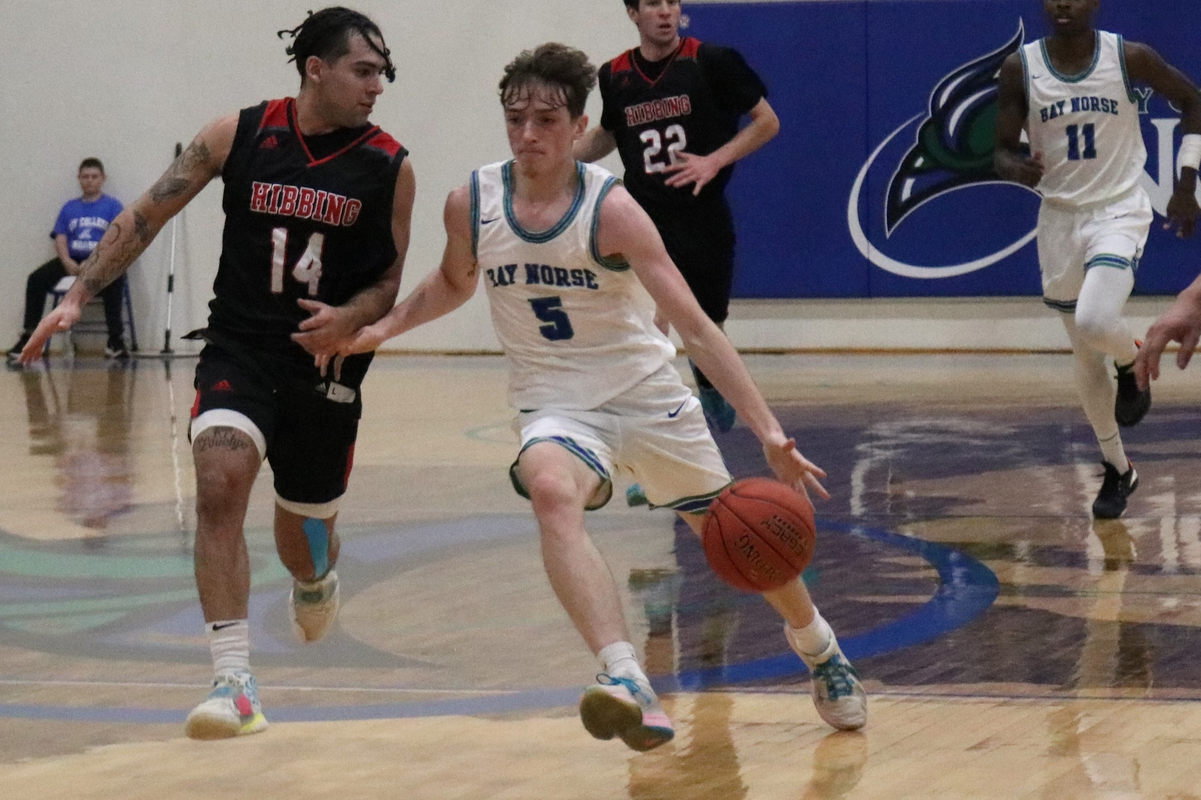 Ryan Sweeney dribbles the ball up the floor with a defender trailing