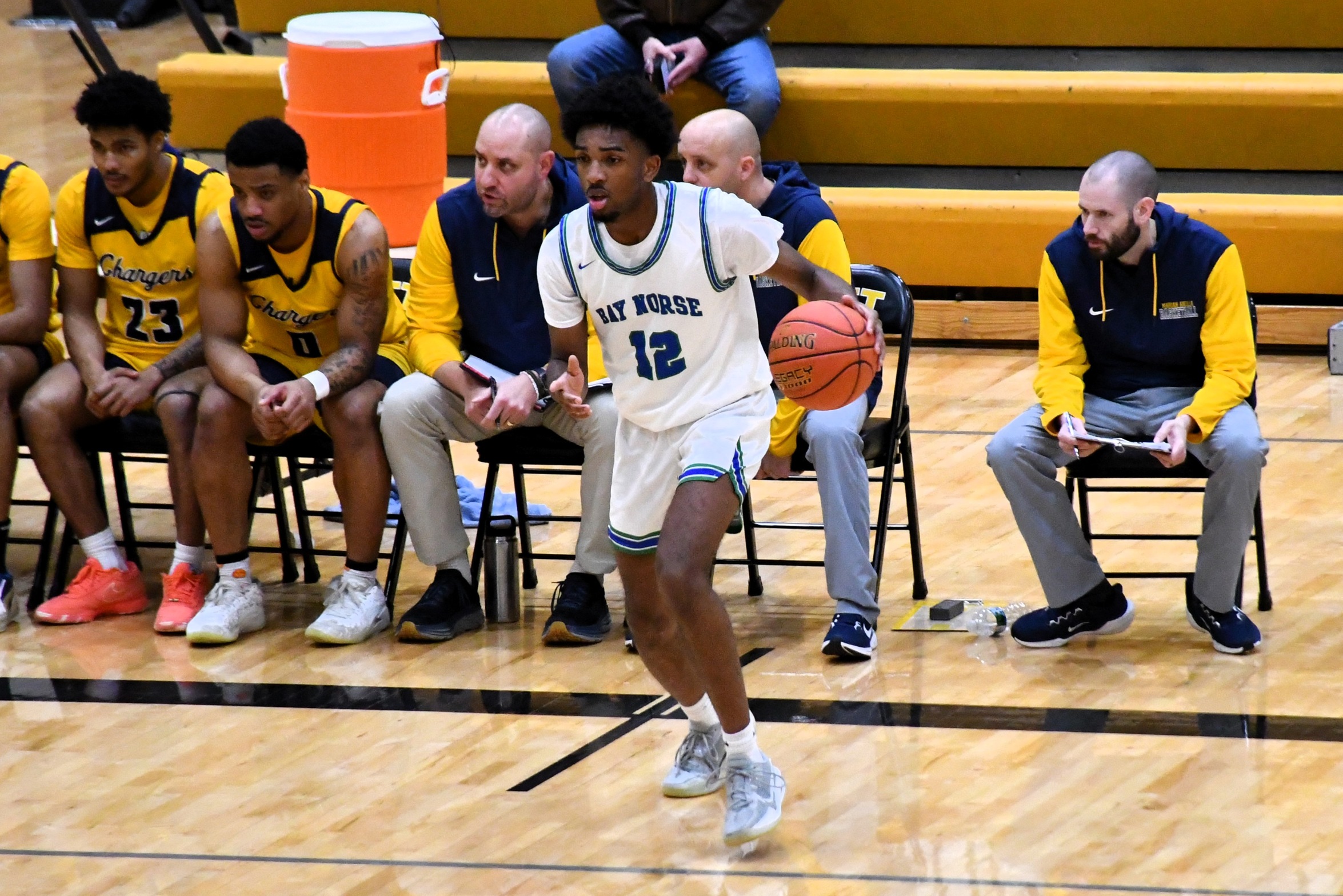 Nic Williams dribbles in front of the opponent's bench