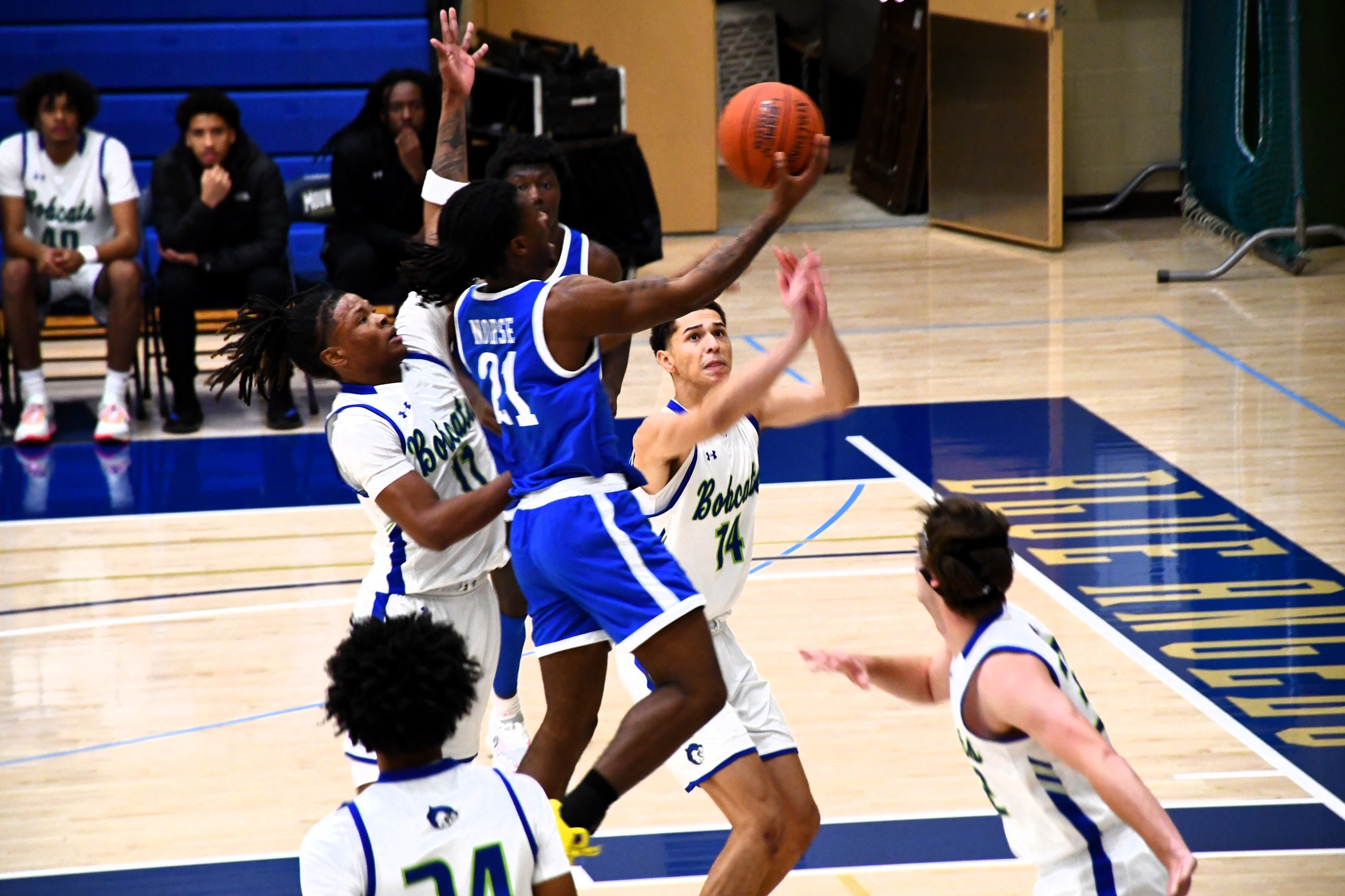D'Marco Chelley going up for a layup with defenders looking on