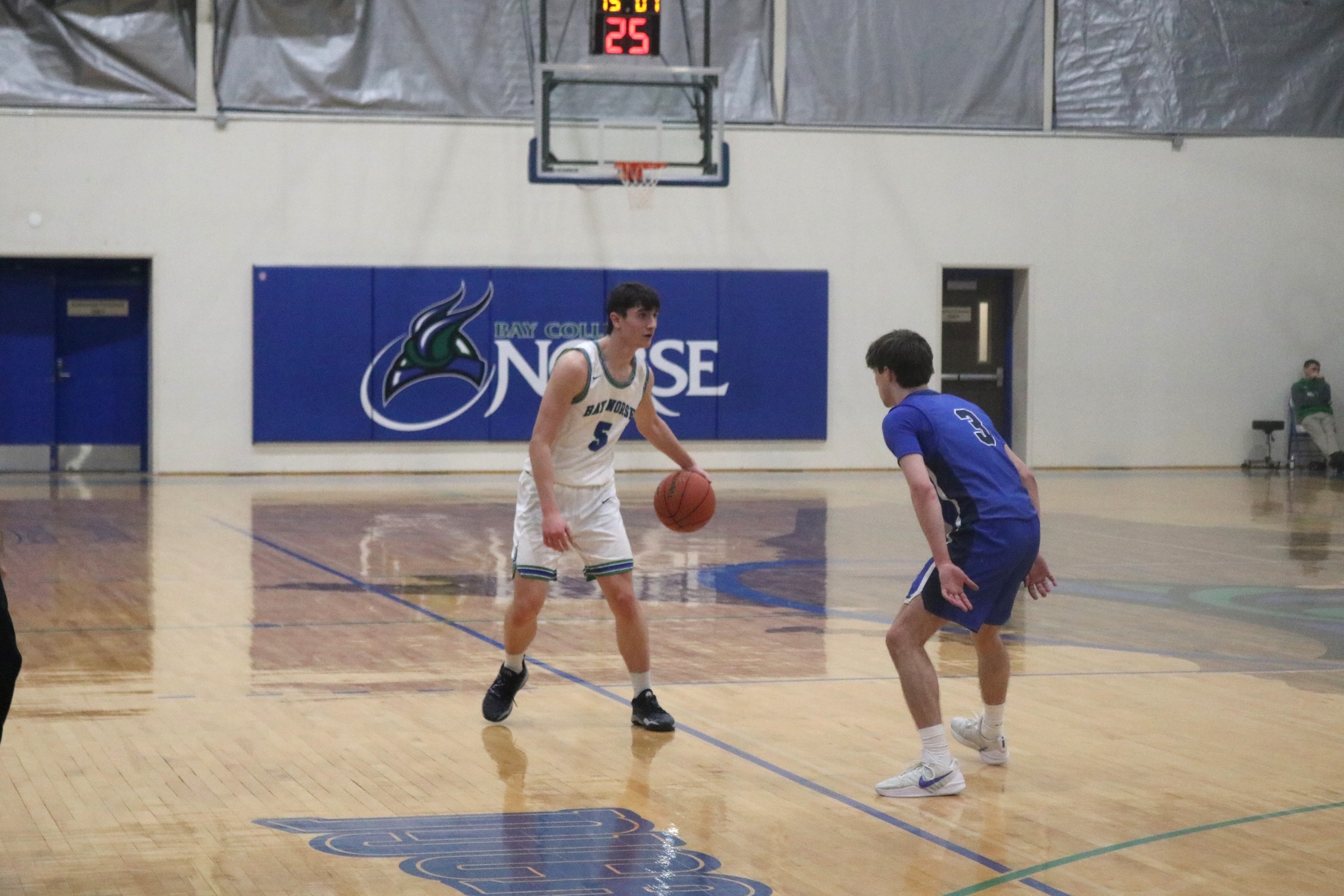 William Kelley dribbles while a defender looks on