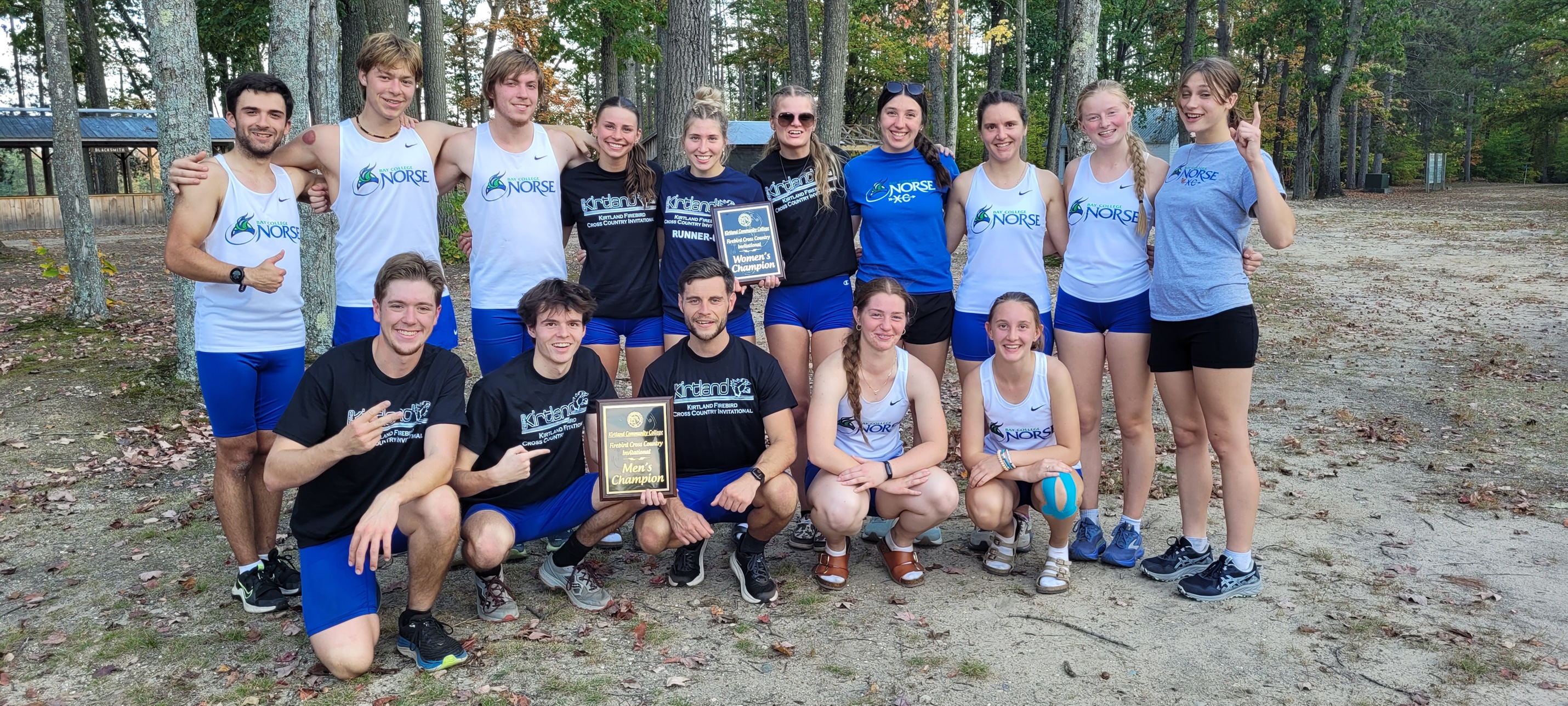 The Norse Men's and Women's Cross Country Teams posing with the team championship plaques