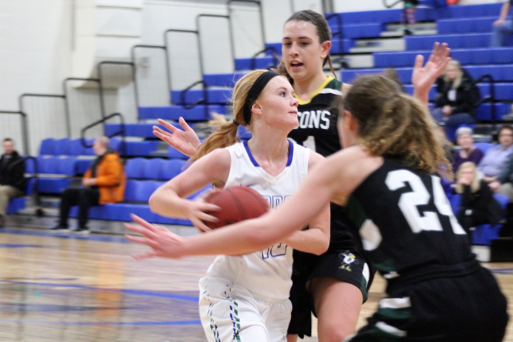 Paige Welch splitting two defenders in the lane