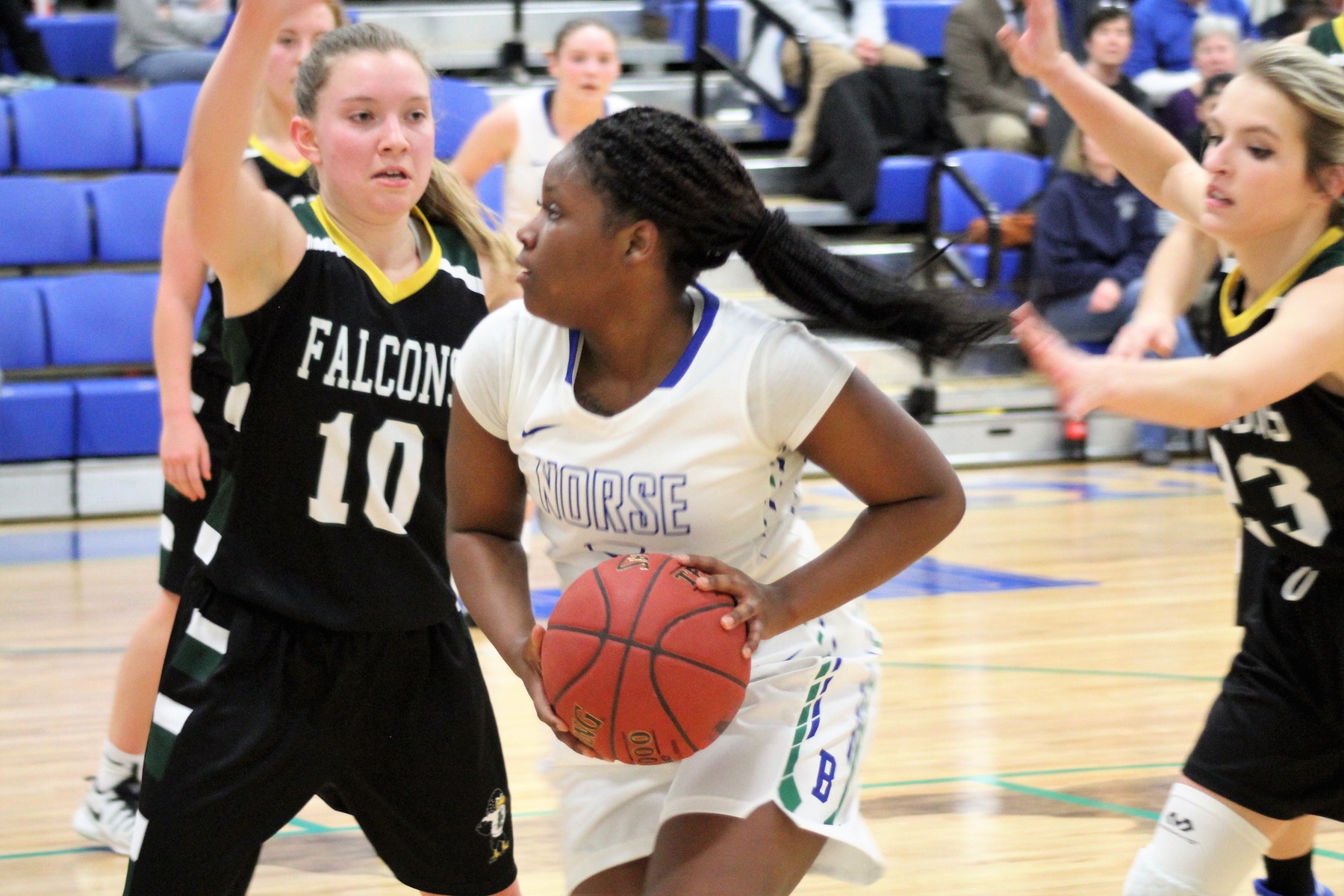 Saige Rogers with the ball as two defenders close in on her