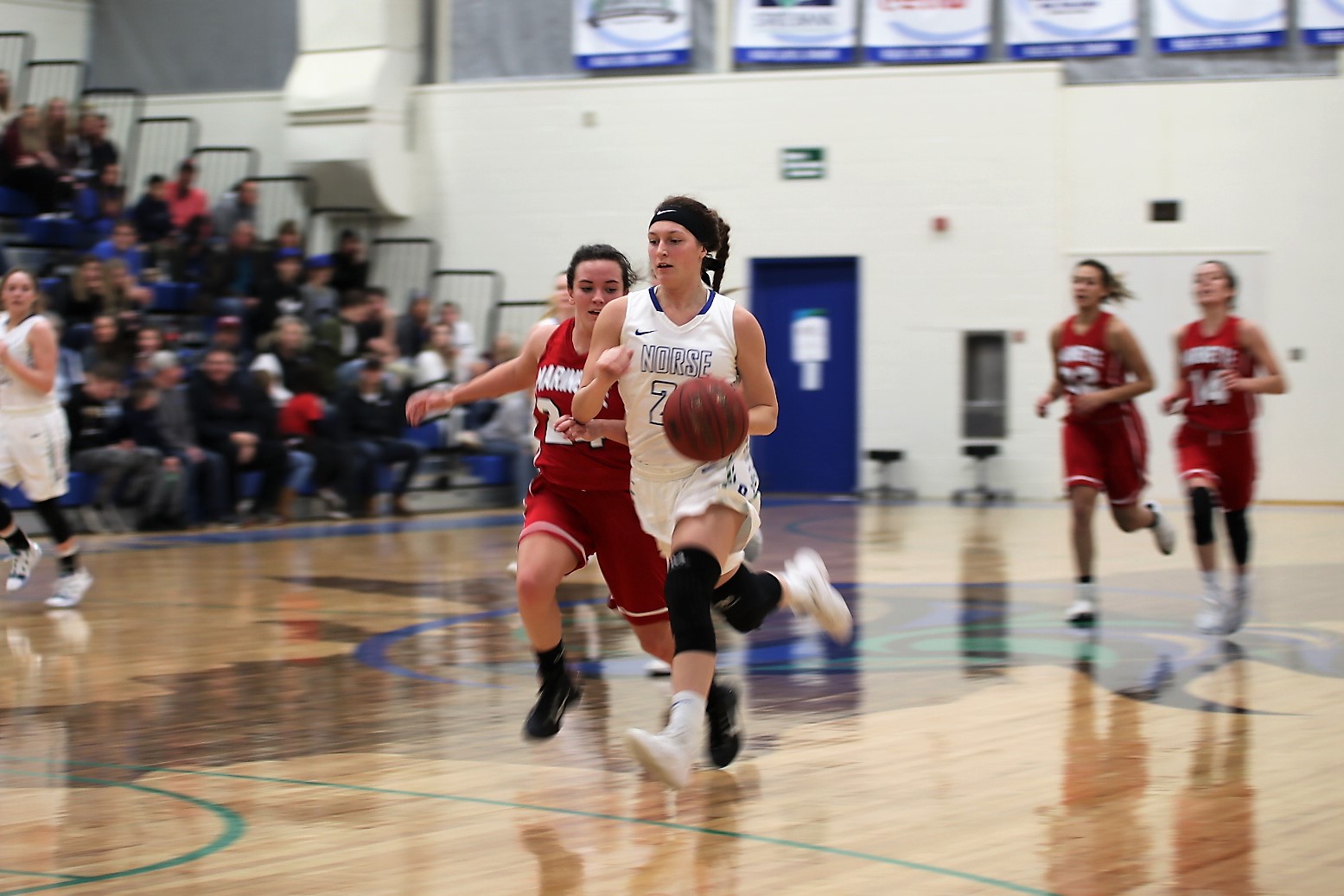 Jordan Kraemer leads a fast break down the floor, several players in pursuit