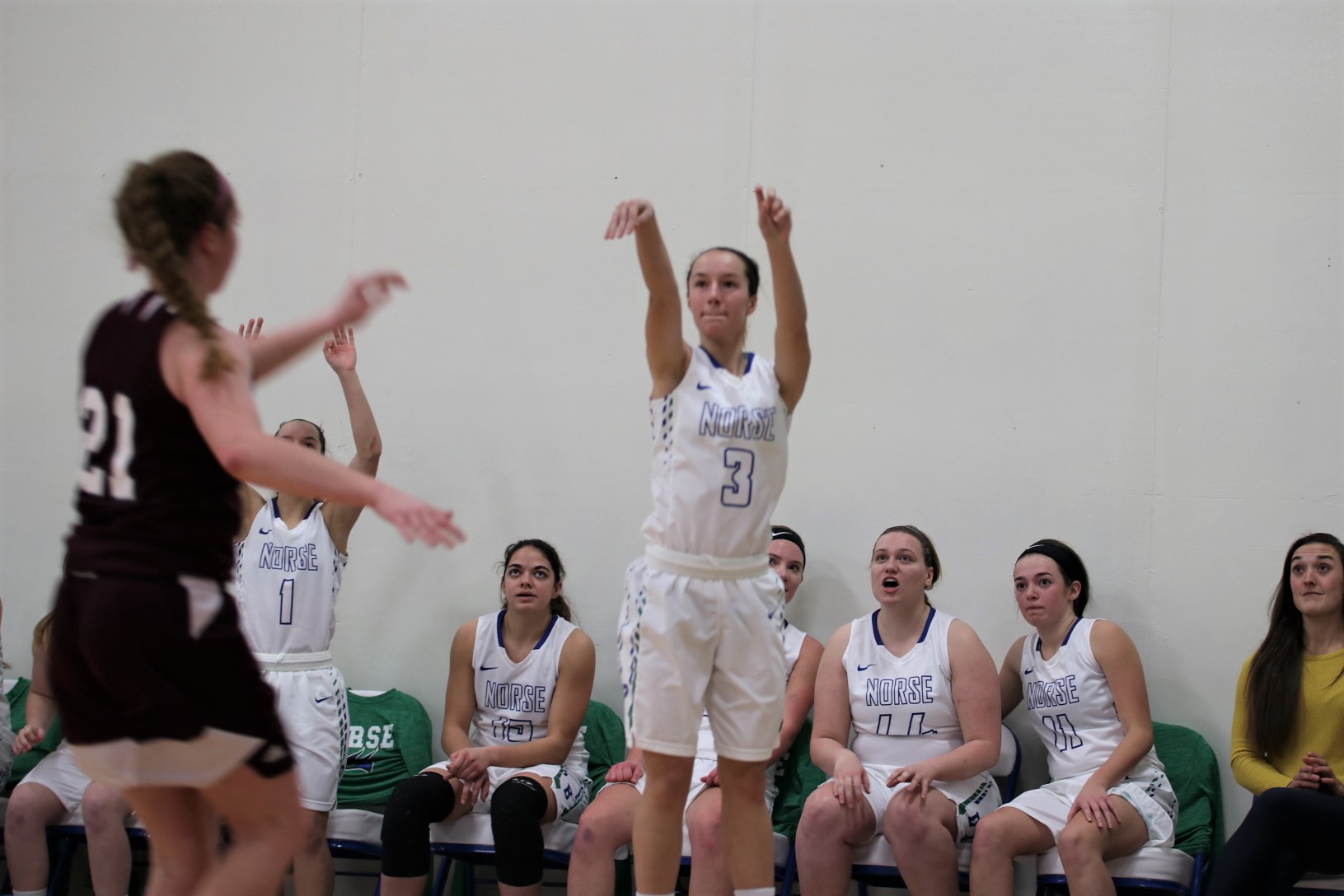 Kelsea Ackerman after just releasing a three-point attempt in front of the Bay bench