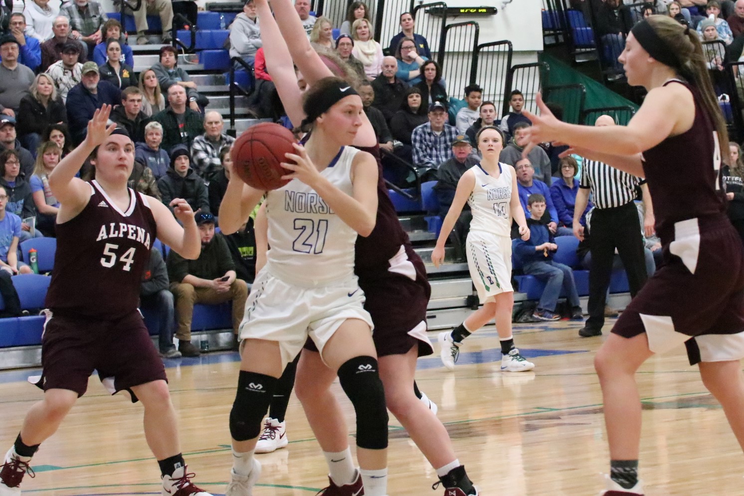 Jordan Kraemer holds the ball as three defenders close in on her