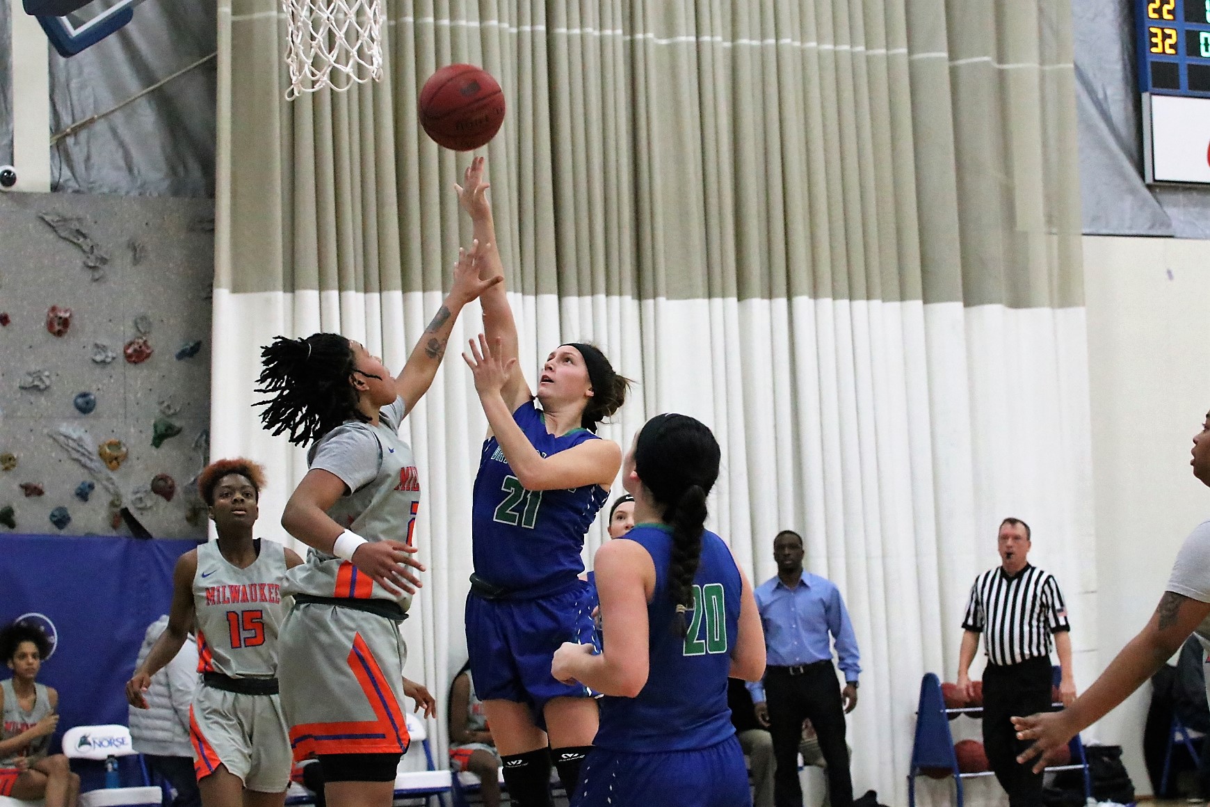 Kraemer watches her shot as it leaves her hand.  An opponents attempt to block the shot has come up short