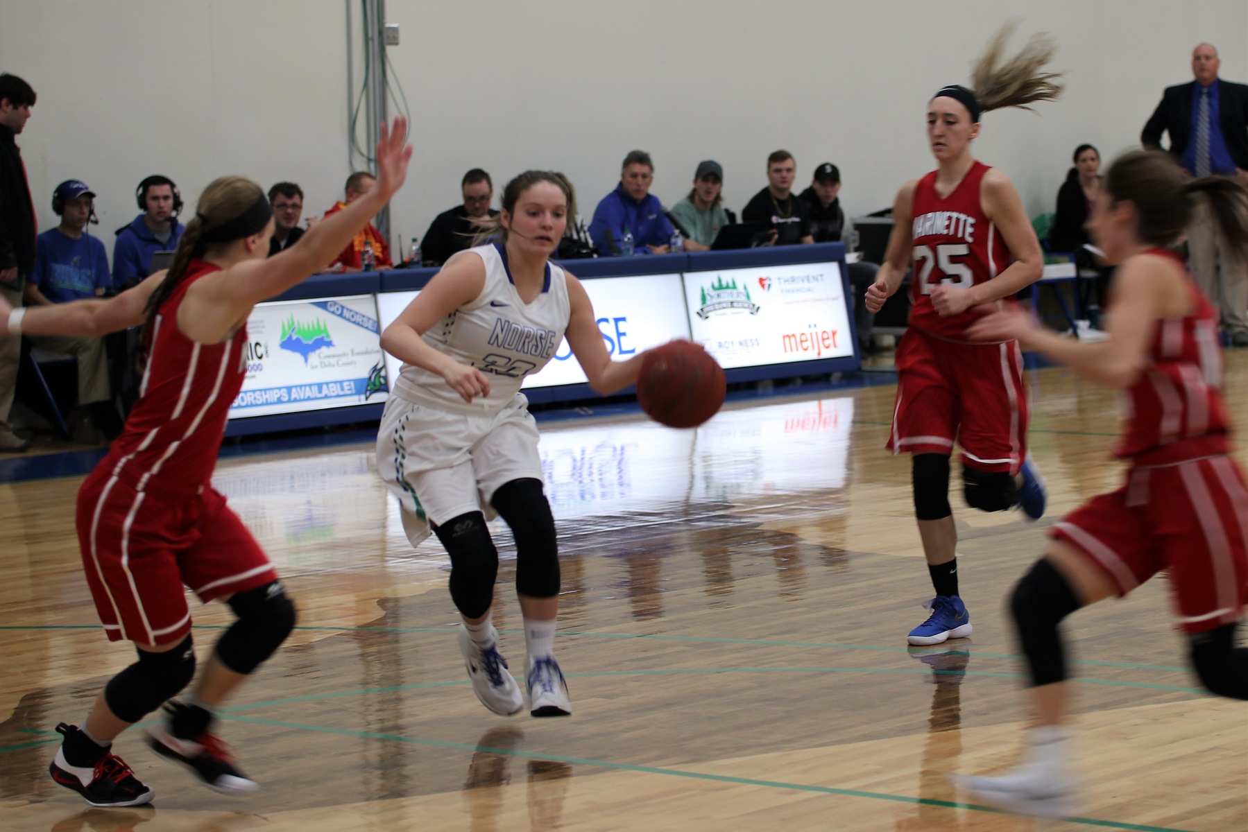 Jordan Belleville dribbling into the lane, splitting three defenders