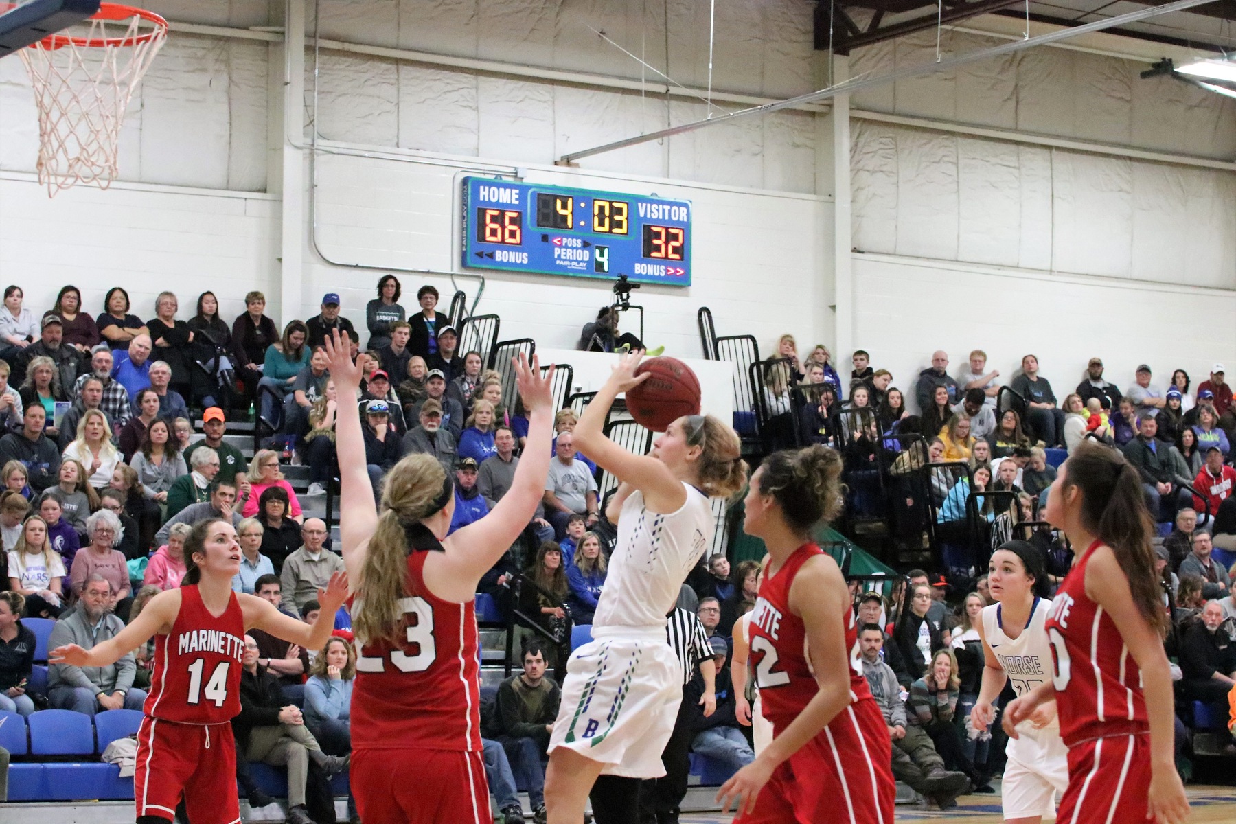 Jordan Kraemer attempting a short jumper in the lane with defenders around her