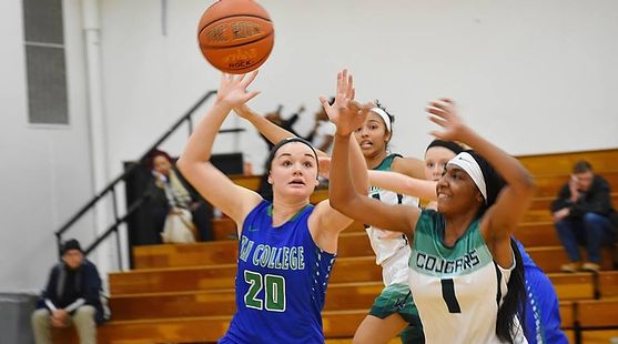Taylor Hunter reaches for a rebound in the air, well a defender tries for the same ball