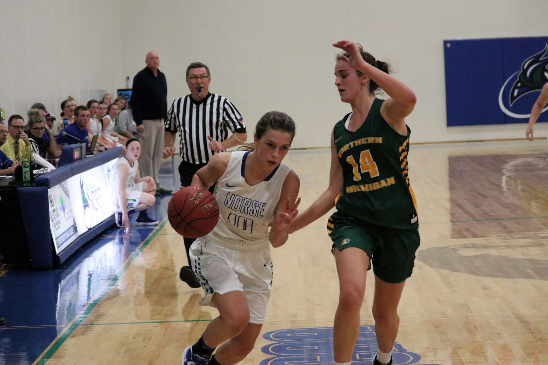 Trish McGuire dribbles up the sideline, a defender closely guarding her