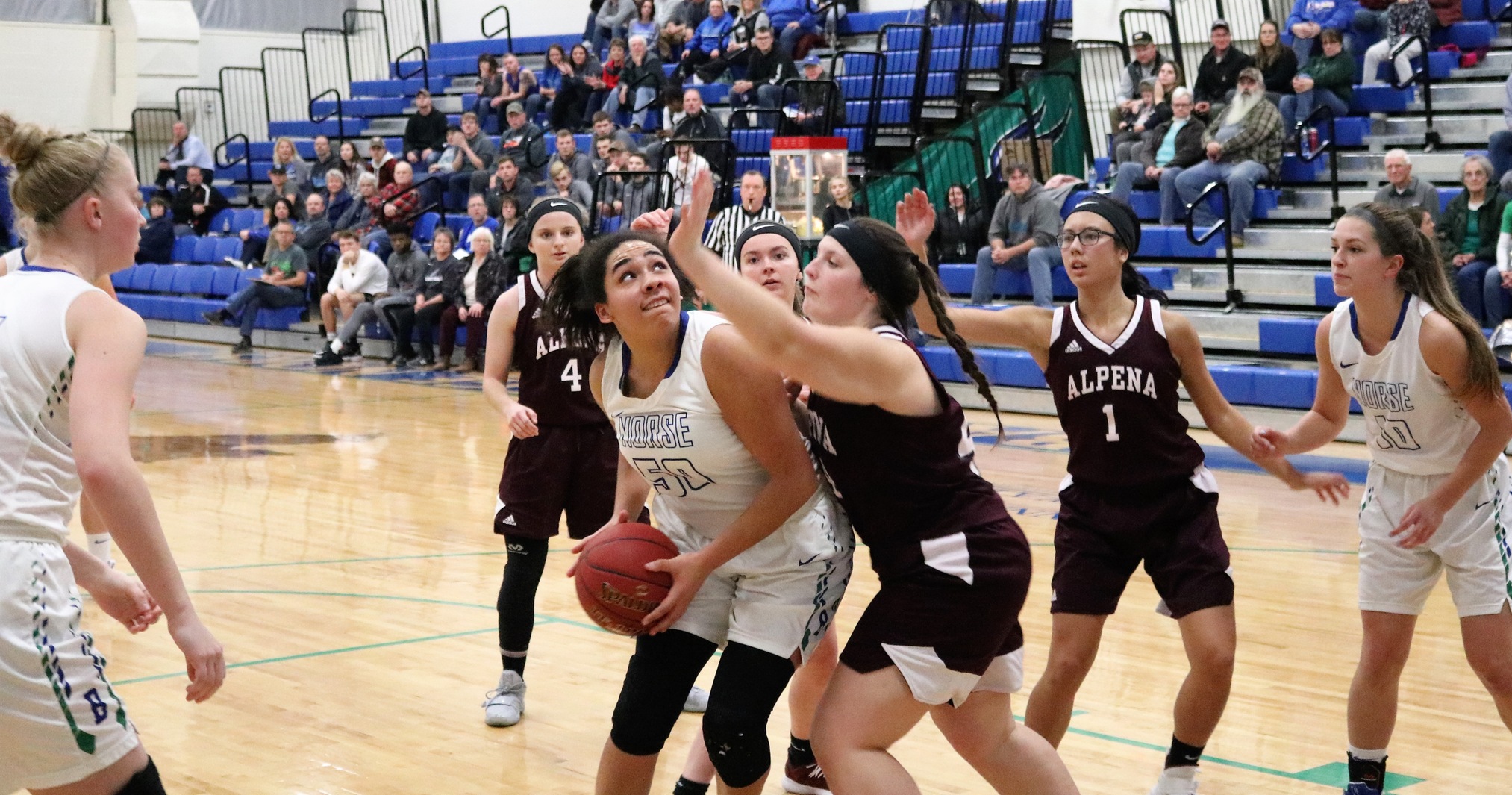Keshia Davis with the ball underneath the basket looking up as a defender reaches over her