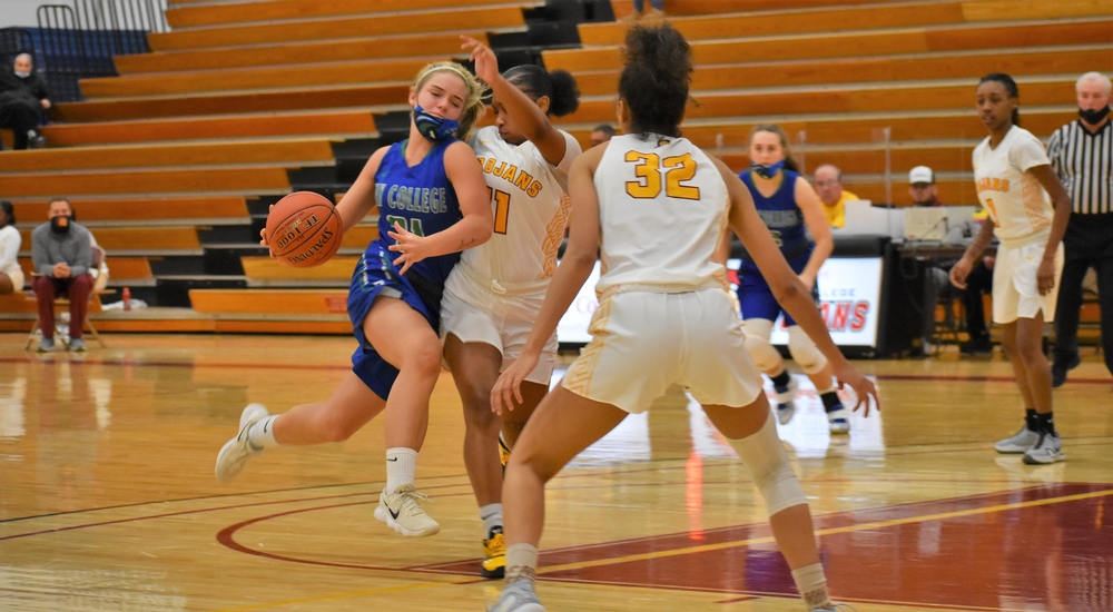Brooke Mannor collides with a defender as she tries to dribble into the lane