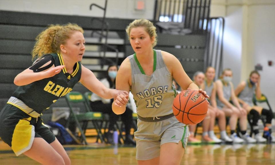 Andie Arsenault dribbles with a defender closely guarding