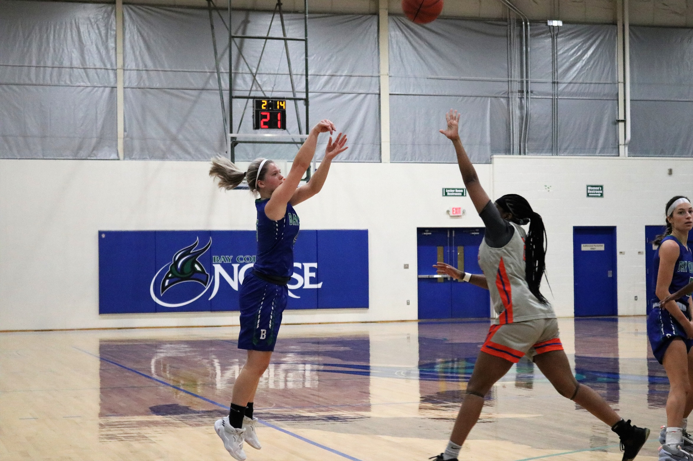 Andie Arsenault in mid air after releasing a three-point attempt