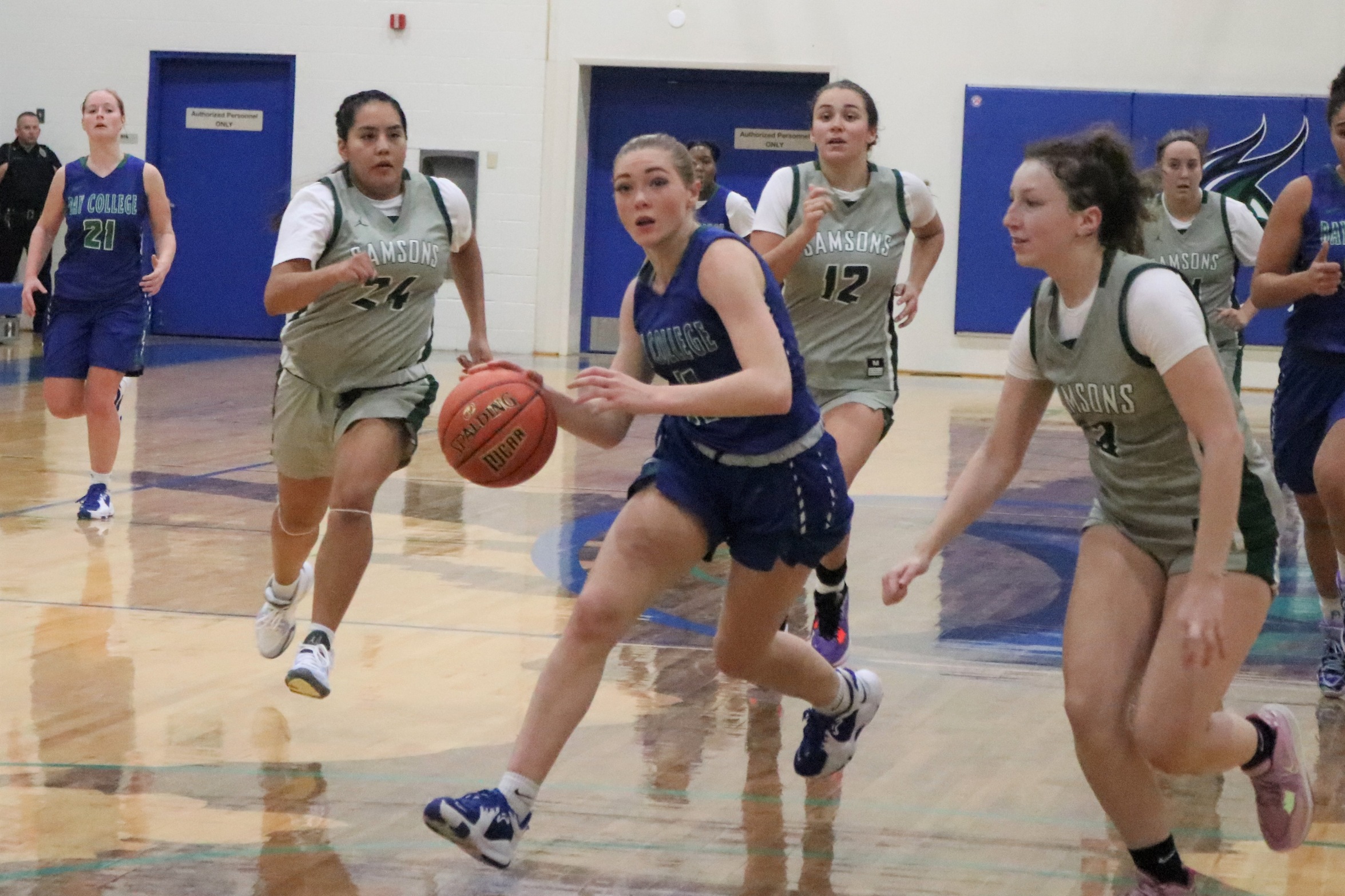 Alyssa Cretton drivign in the lane, as defenders look on