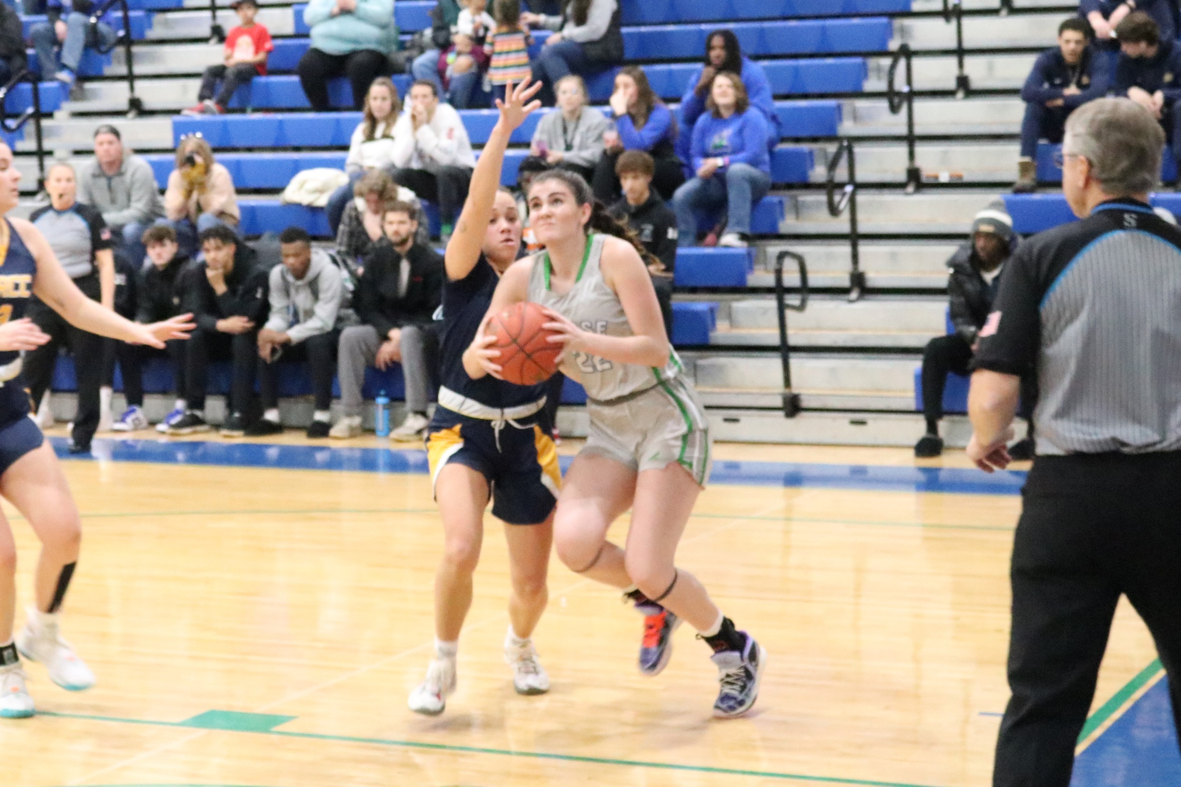 Kassidy Roll going to the rim with a defender on her hip