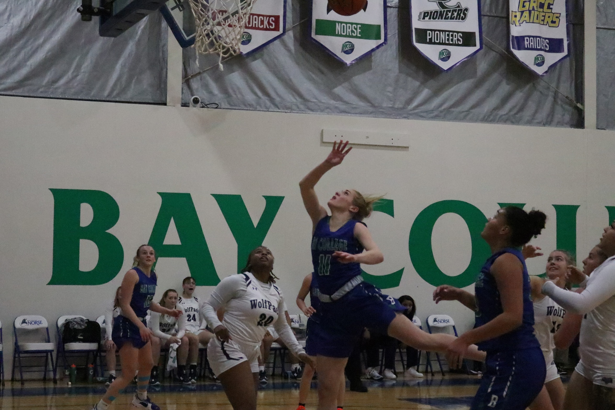 Alyssa Cretton in the lane watches as her shot floats toward the rim