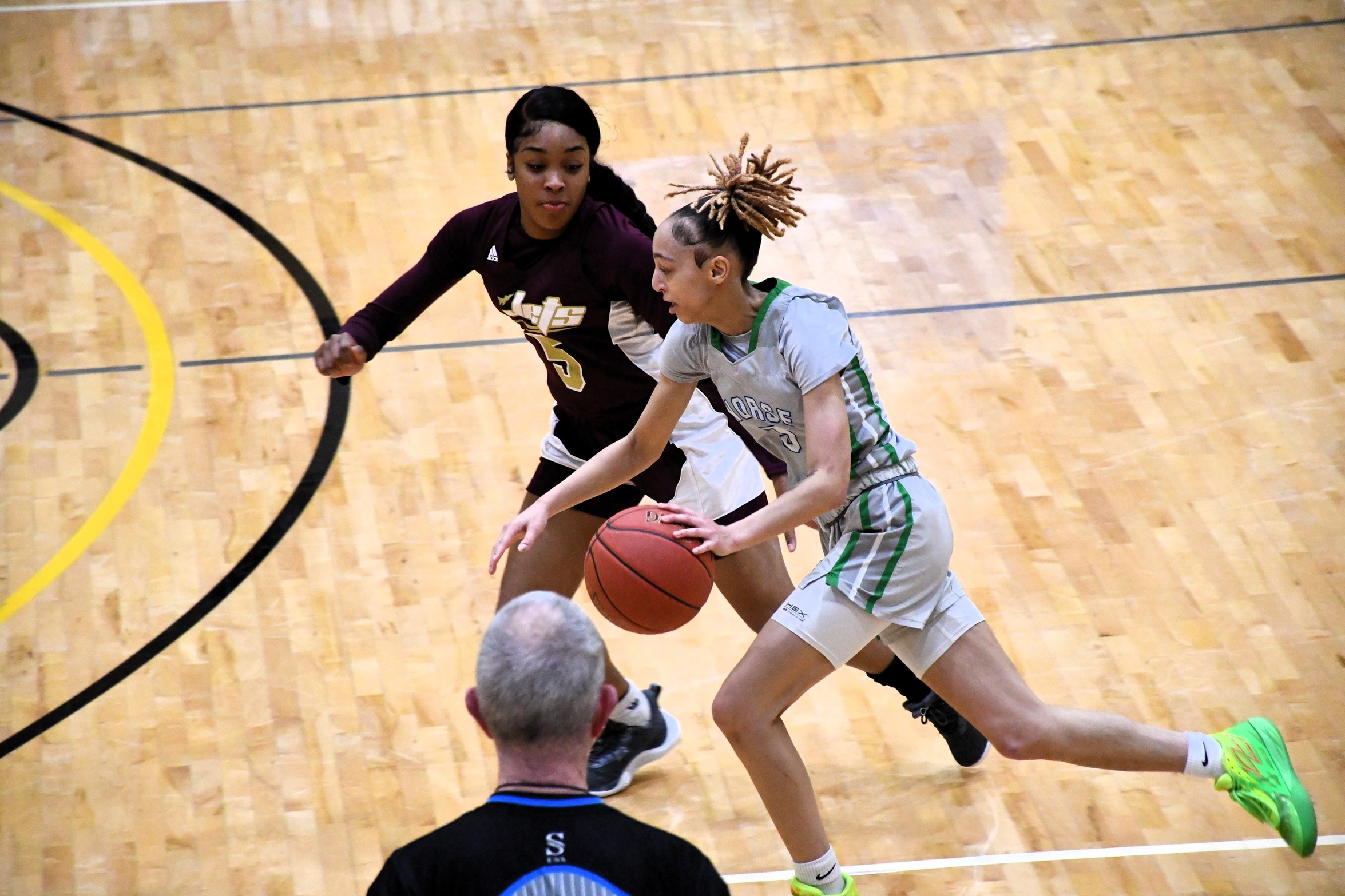 Ashlee Burchette pushes her dribble forward with a defender trying to keep up