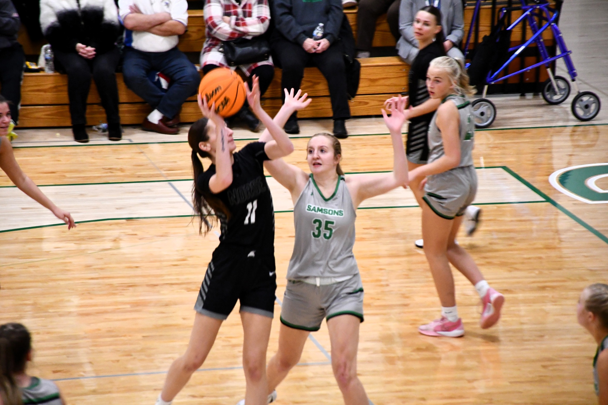Kennedy Sproule going up for a shot in the lane while a defender closes in
