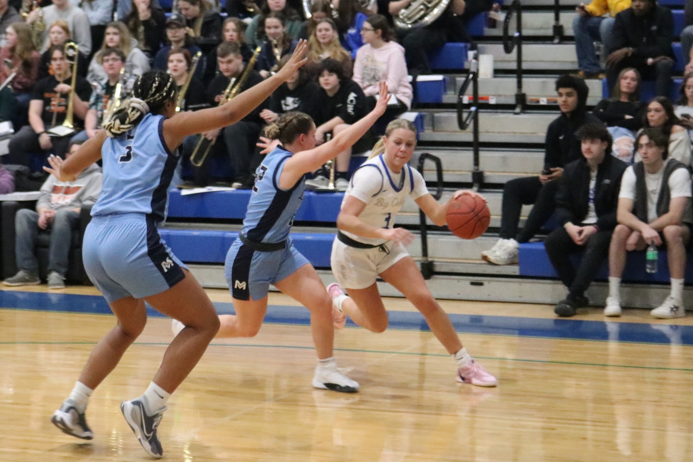 Anna Axtell dribbles past a defender as another closes in to help