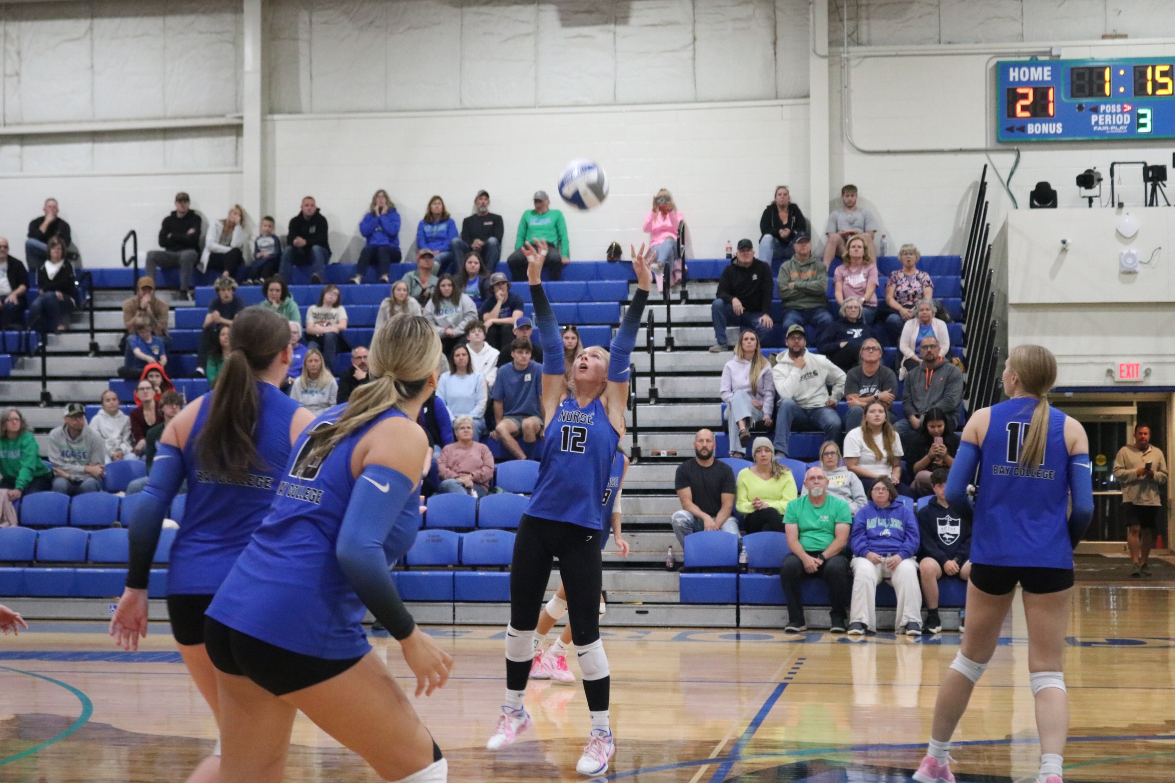 Audrey Franz setting the ball as her teammates look on